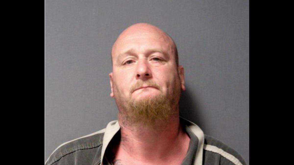 Lee Mouat Jr., 42, was arrested after Michigan police said he hit an 18-year-old black man in the face with a bike chain. He faces a number of charges including ethnic intimidation.