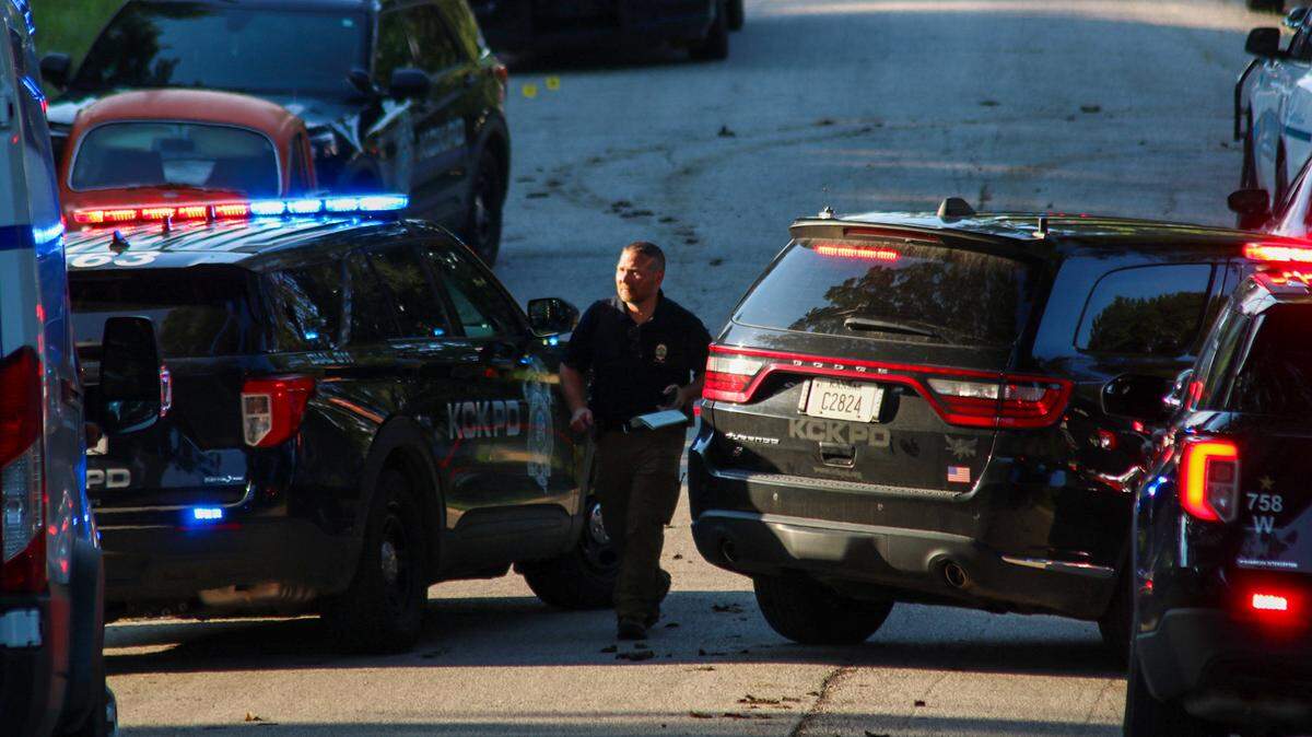 A police officer heads into the site of a shooting on Saturday, July 26, in the Argentine neighborhood of Kansas City, Kansas.