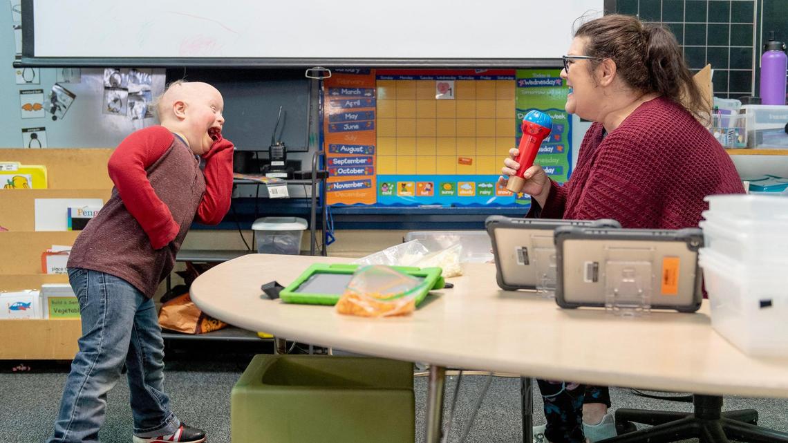Alexa Scarlett, a special education teacher in the Shawnee Mission school district, sings a song from the Disney movie “Moana” with student Crosby Orlando. Parents say special ed classes are understaffed and under-resourced.