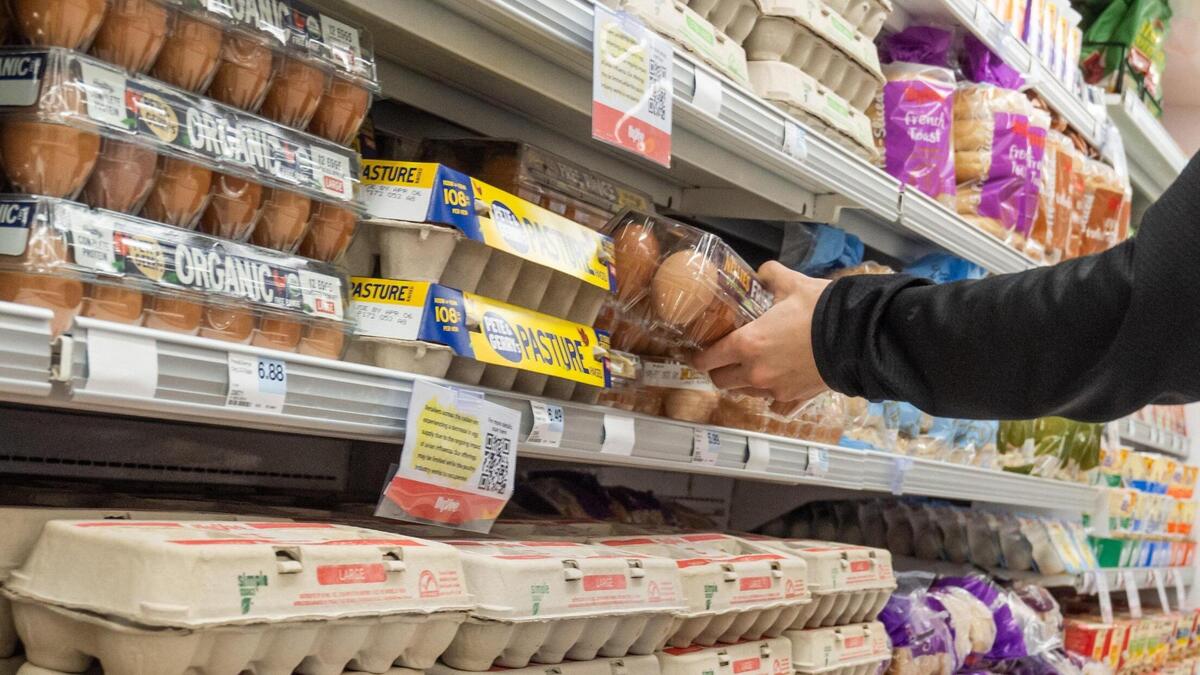 A customer selects a carton of eggs on Wednesday, Feb. 25, in Mission. There is currently a nationwide egg shortage based on several factors including bird flu.