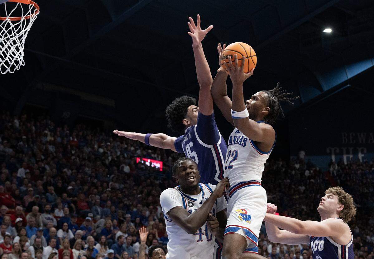 TCU Horned Frogs forward David Punch (15) defends as Kansas Jayhawks guard Darryn Peterson (22) shoots during the first half at Allen Fieldhouse in Lawrence on Tuesday, Jan. 6, 2025.