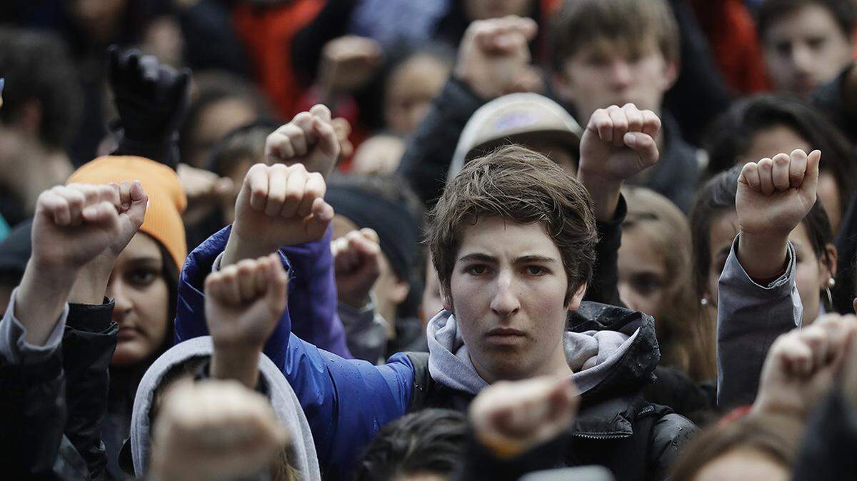 In this March 14, 2018 file photo, demonstrators raise their fists in the air during a student-led march against gun violence at the Civic Center Plaza in San Francisco.