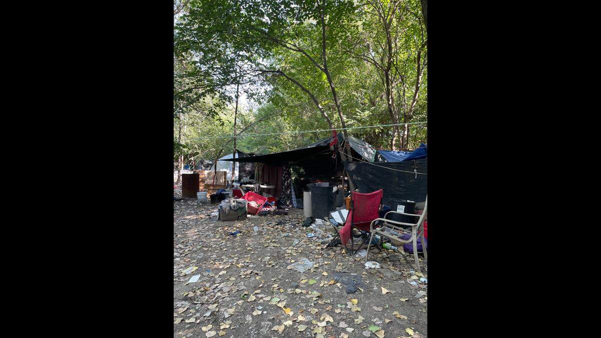 Outreach workers with the city visit a homeless encampment near Kessler Park in Kansas City.