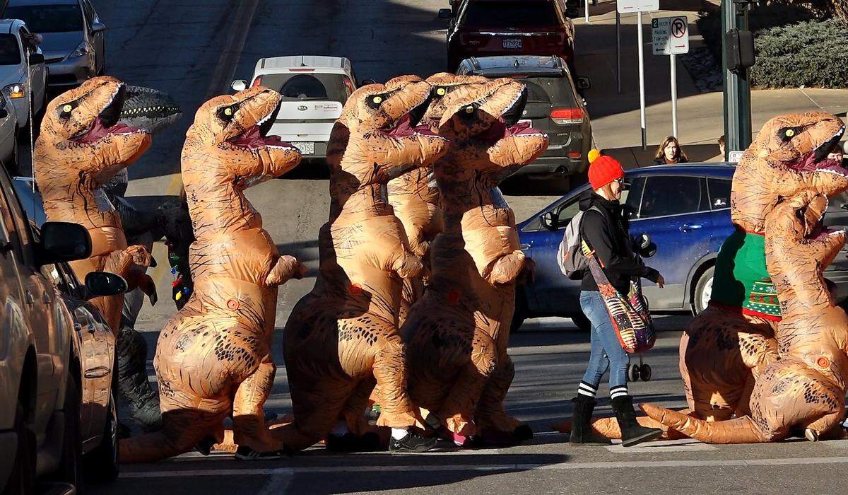 Two days before Christmas in 2018, dozens of dinosaurs roamed and waddled around the Country Club Plaza on their second annual march, surprising and delighting shoppers and visitors to the Plaza.