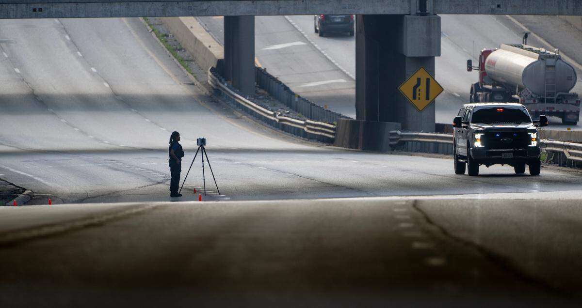 A Kansas City police officer works the scene of a fatal shooting on westbound lanes of Interstate 670 near Broadway Boulevard on Wednesday, June 7, 2023, in Kansas City.