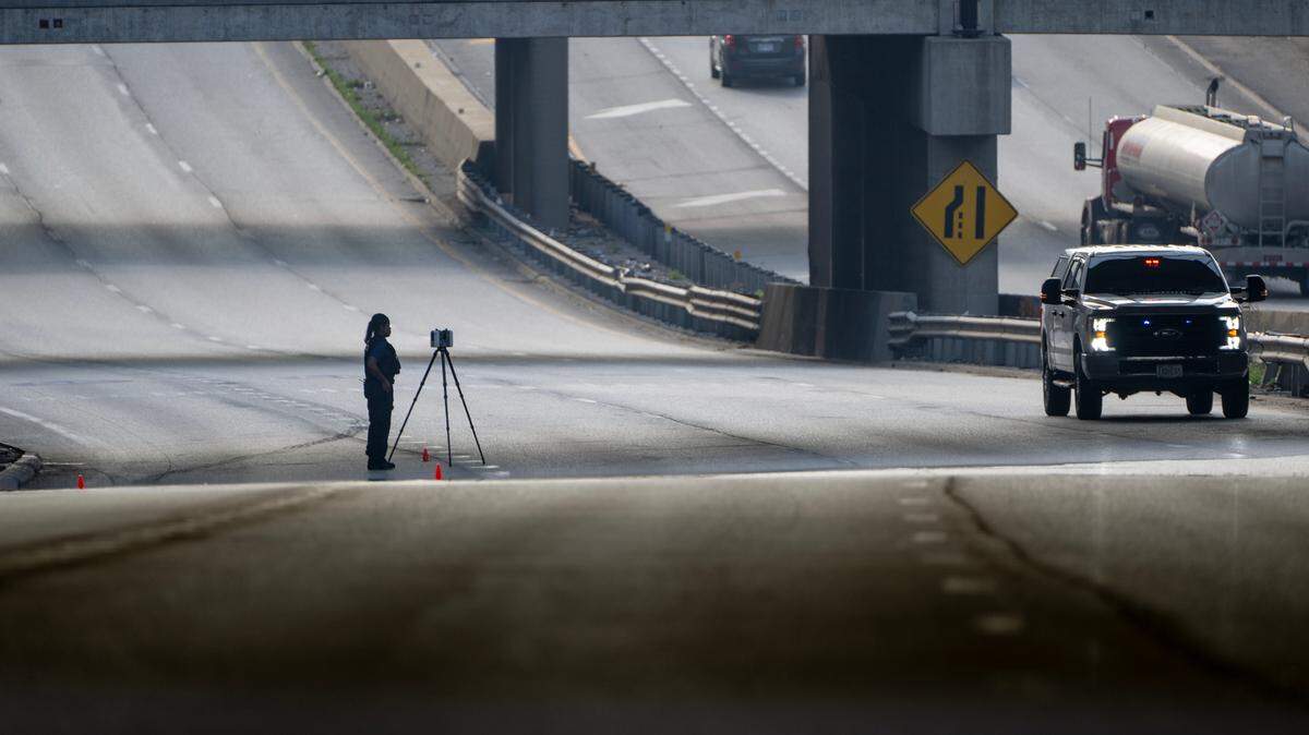 A Kansas City police officer works the scene of a fatal shooting on westbound lanes of Interstate 670 near Broadway Boulevard on Wednesday, June 7, 2023, in Kansas City.