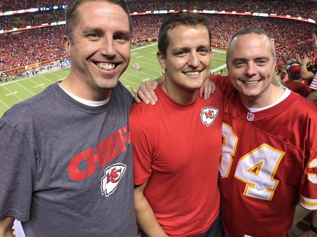 Cory Strathman, center, says Chris Lash, right, and Kevin Frick, both Shawnee Mission principals, are two friends he confided in about his depression. They are pictured at Arrowhead Stadium.