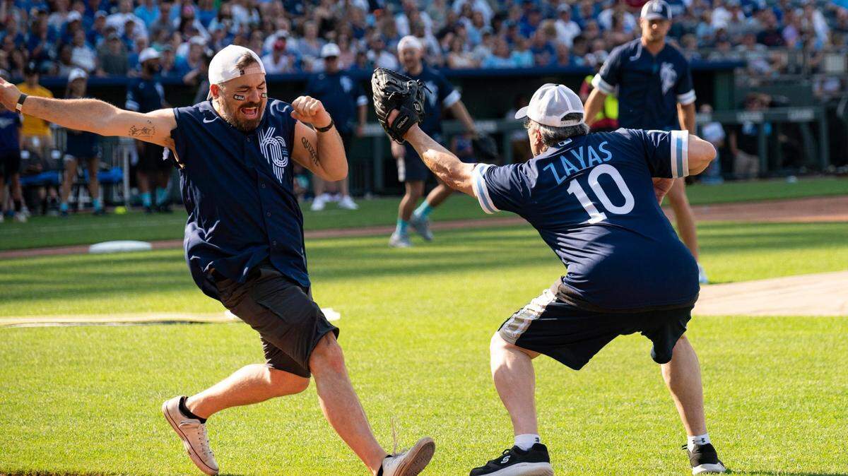 Brian “Q” Quinn of “Impractical Jokers” lunges for first base as David Zayas (“Dexter”) tries to tag him out during the 2022 Big Slick celebrity softball game at Kauffman Stadium. Quinn and his fellow cast members will appear at this year’s event.