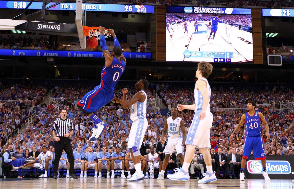 Thomas Robinson #0 of the Kansas Jayhawks dunks against Reggie Bullock #35 of the North Carolina Tar Heels during the 2012 NCAA Men's Basketball Midwest Regional Final at Edward Jones Dome on March 25, 2012, in St Louis, Missouri.