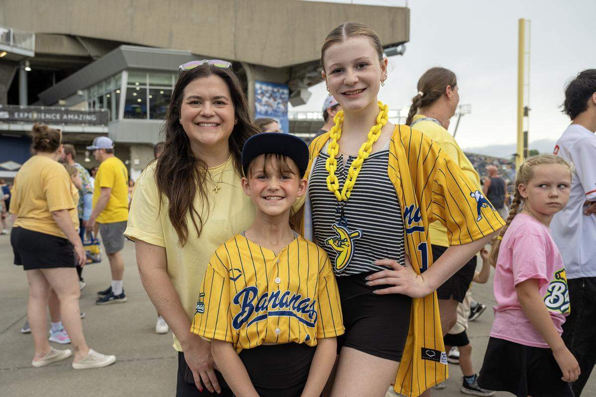 Kaitlynn Conrad, left, poses for a photo with her daughters, 10-year-old Riley and 12-year-old Amelia, of Omaha, Neb., before a Banana Ball game between the Savannah Bananas and Indianapolis Clowns at Kauffman Stadium on Saturday, May 30, 2026, in Kansas City.