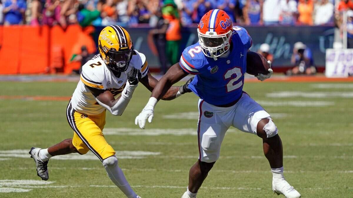 Florida running back Montrell Johnson Jr., right, tries to get past Missouri defensive back Ennis Rakestraw Jr. during Saturday’s game in Gainesville, Fla.