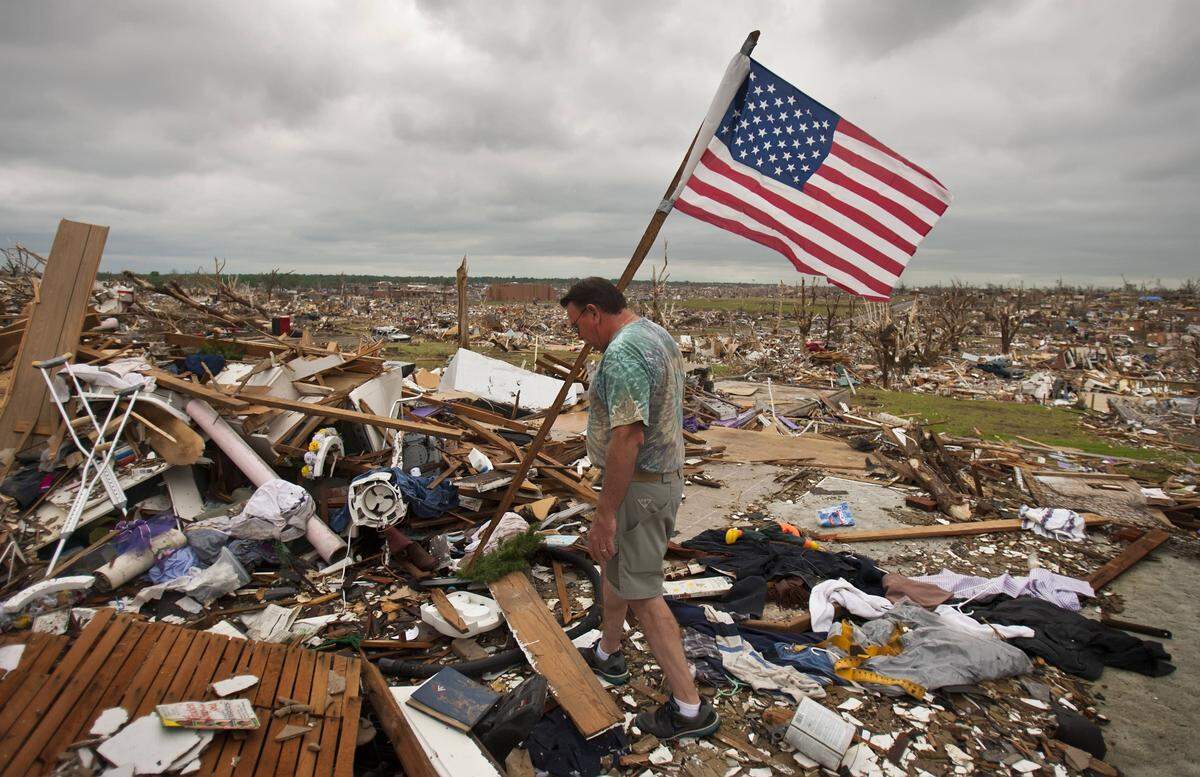 Eight years ago Wednesday, Joplin was hit by one of the most devastating tornadoes in U.S. history. In this file photo, David Blank looked for a spot to place an American flag found in the rubble of a home he was helping clean up.