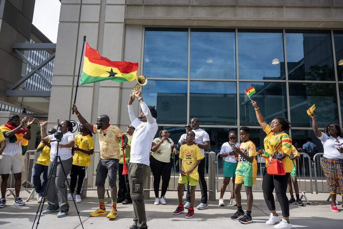 Ghana supporters cheer outside the Sheraton Kansas City Hotel while waiting for the Ghana national team to arrive on Wednesday, July 1, 2026.