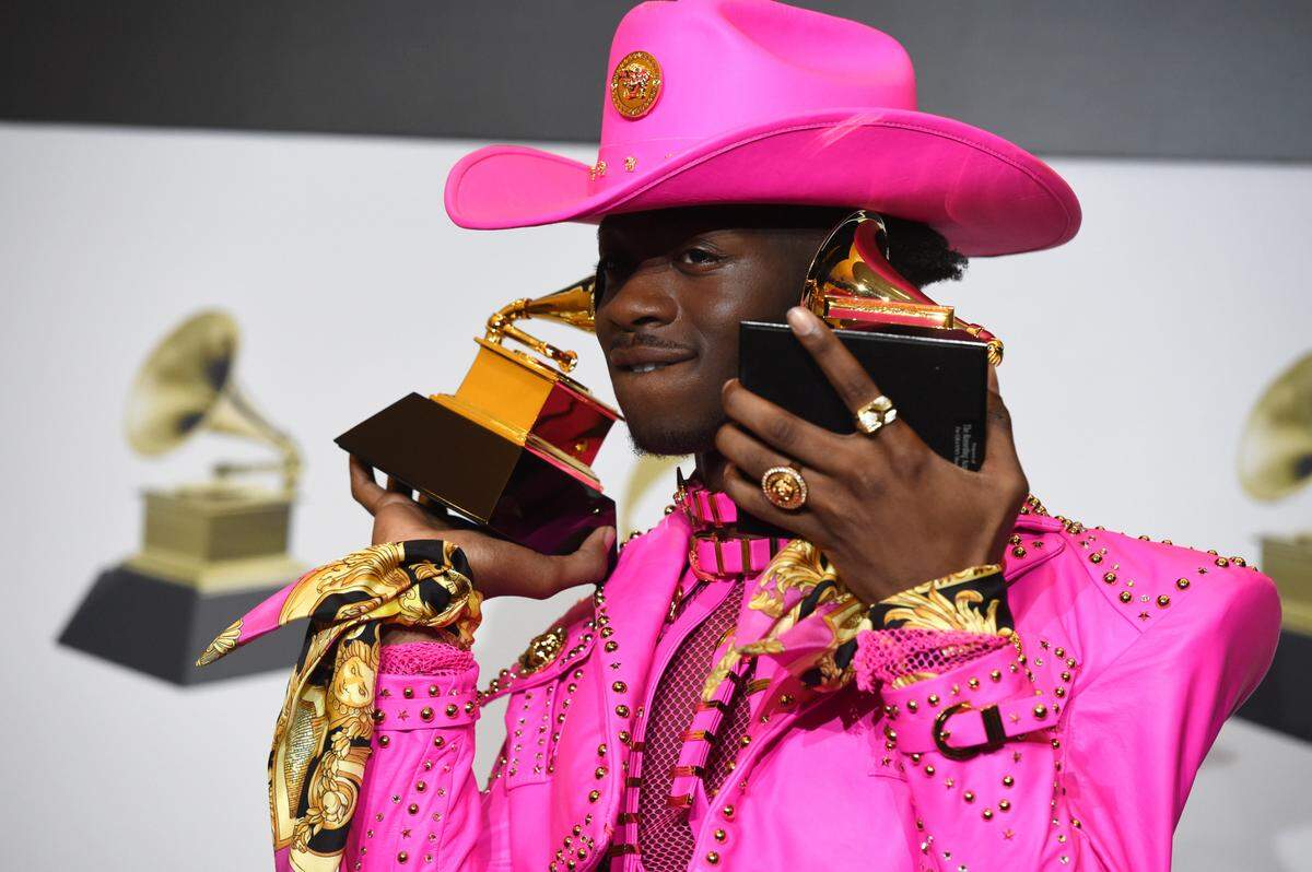 Lil Nas X poses in the press room with the awards for best music video and best pop duo/group performance for “Old Town Road,” at the 62nd annual Grammy Awards at the Staples Center on Sunday, Jan. 26, 2020, in Los Angeles. (AP Photo/Chris Pizzello)