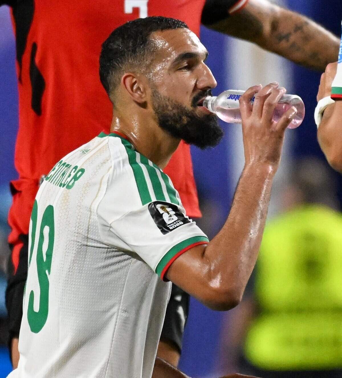 Algeria midfielder Nabil Bentaleb (19) takes a drink during a hydration break in the first half of the World Cup game between Algeria and Austria at Kansas City (Arrowhead) Stadium on Saturday, June 27, 2026.