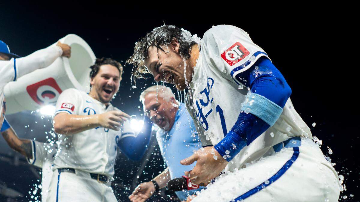 Kansas City Royals designated hitter Vinnie Pasquantino (9), shortstop Bobby Witt Jr. (7) and broadcaster Joel Goldberg are doused by first baseman Salvador Perez (13) and left fielder MJ Melendez (1) after defeating the Boston Red Sox at Kauffman Stadium on Aug. 7, 2024.