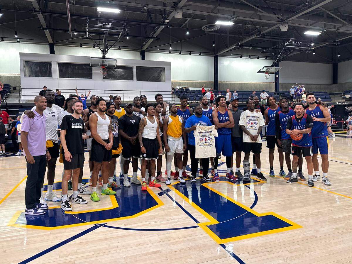 The Kansas State and Kansas alumni teams pose for a photo following the conclusion of the first Wheat State Summer Showdown at Johnson County Community College. Purple Reign, led by Jacob Pullen, pulled out a 76-72 victory on July 17, 2024.