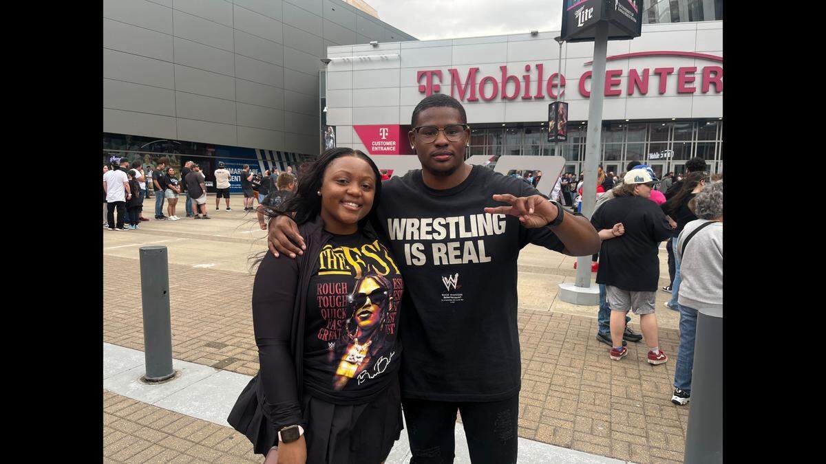 Robert Raymond (left) and his wife are from Lee’s Summit and have been to the last few WWE shows in Kansas City. Raymond said the best way to convert a new fan is take them to a live event.