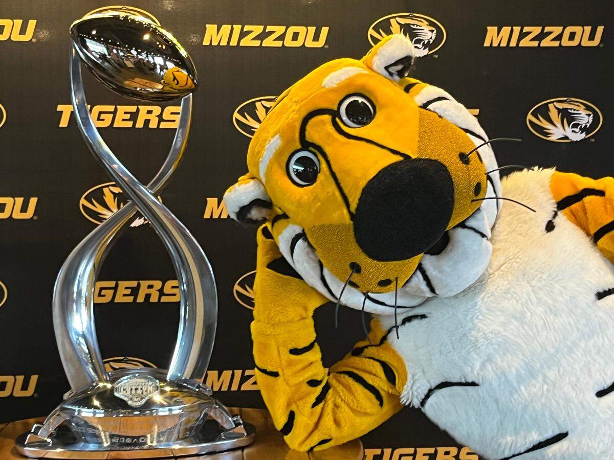 Missouri Tigers mascot Truman poses with the Cotton Bowl trophy, won by Mizzou with a 14-3 victory over Ohio State.