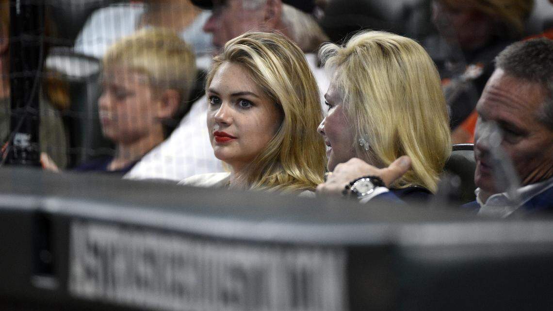 Kate Upton, center, wife of Houston Astros pitcher Justin Verlander, attends Game 2 of a baseball American League Division Series between the Houston Astros and the Cleveland Indians, Saturday, Oct. 6, 2018, in Houston. (AP Photo/Eric Christian Smith)