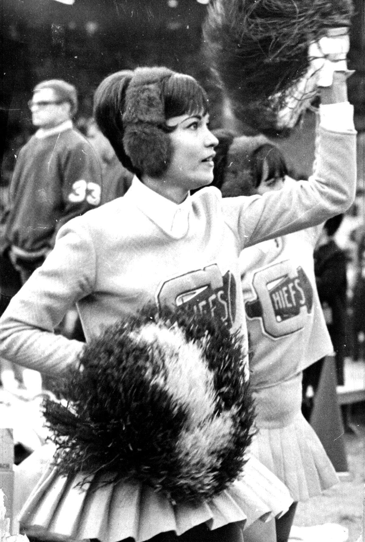 From secretary to Chiefs cheerleader, Margaret Sprague cheers for the team on the sidelines. During the week in 1967, she and her sister were private secretaries to Jack Steadman, Chiefs general manager and executive vice-president for the team.