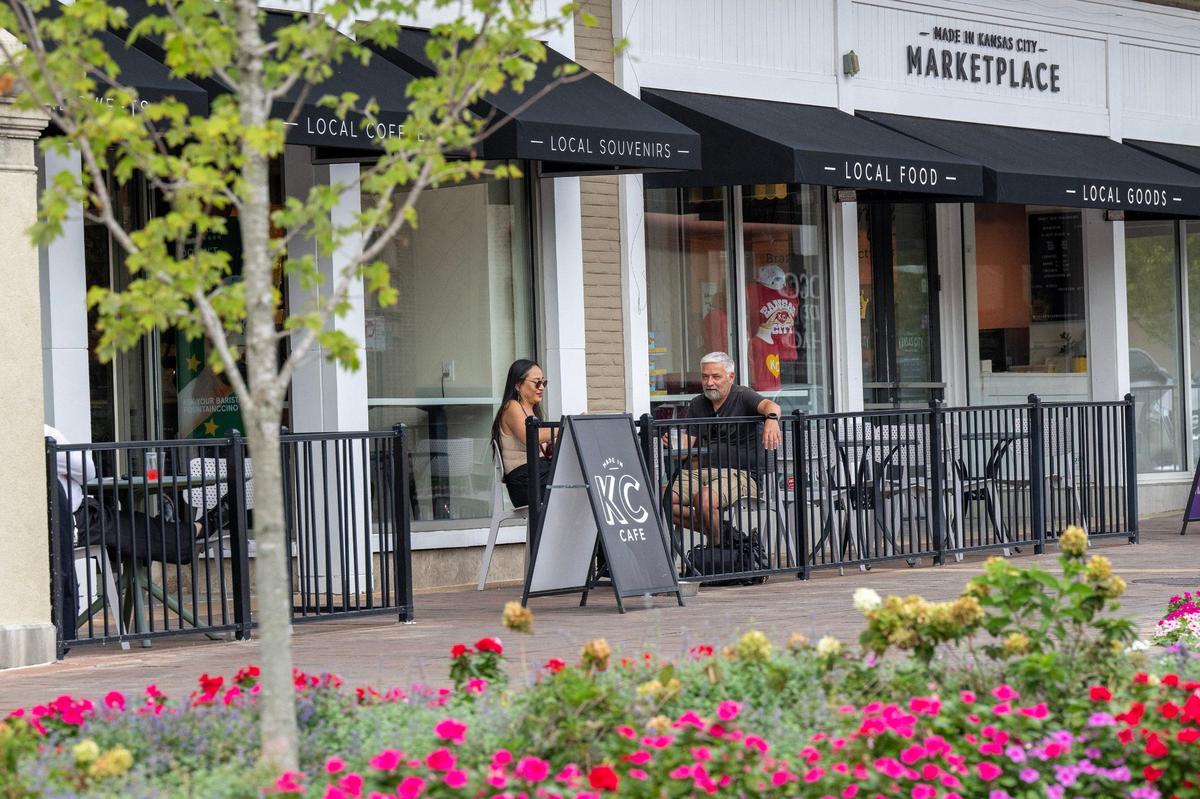 Visitors relax on the patio of Made in Kansas City Marketplace at the Country Club Plaza, purchased in June by HP Village Partners of Dallas.