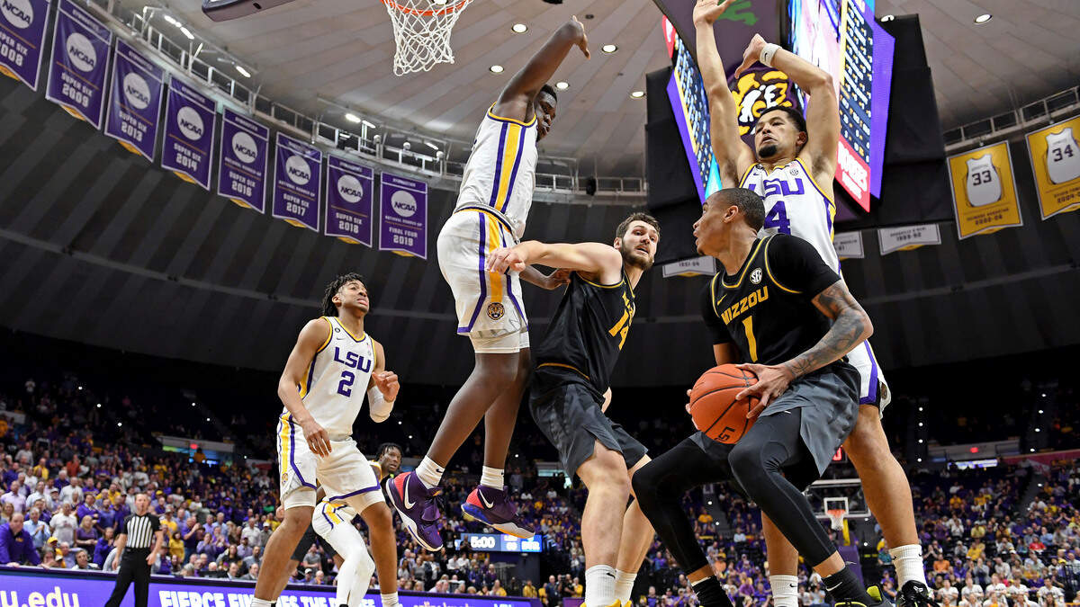 Missouri guard Xavier Pinson (1) drives to the basket but finds heavy traffic in the form of LSU guard Skylar Mays, right top, and LSU forward Darius Days (0) as Missouri forward Reed Nikko (14) tries to help in the second half of an NCAA college basketball game, Tuesday, Feb. 11, 2020, in Baton Rouge, La. LSU won 82-78. (AP Photo/Bill Feig)