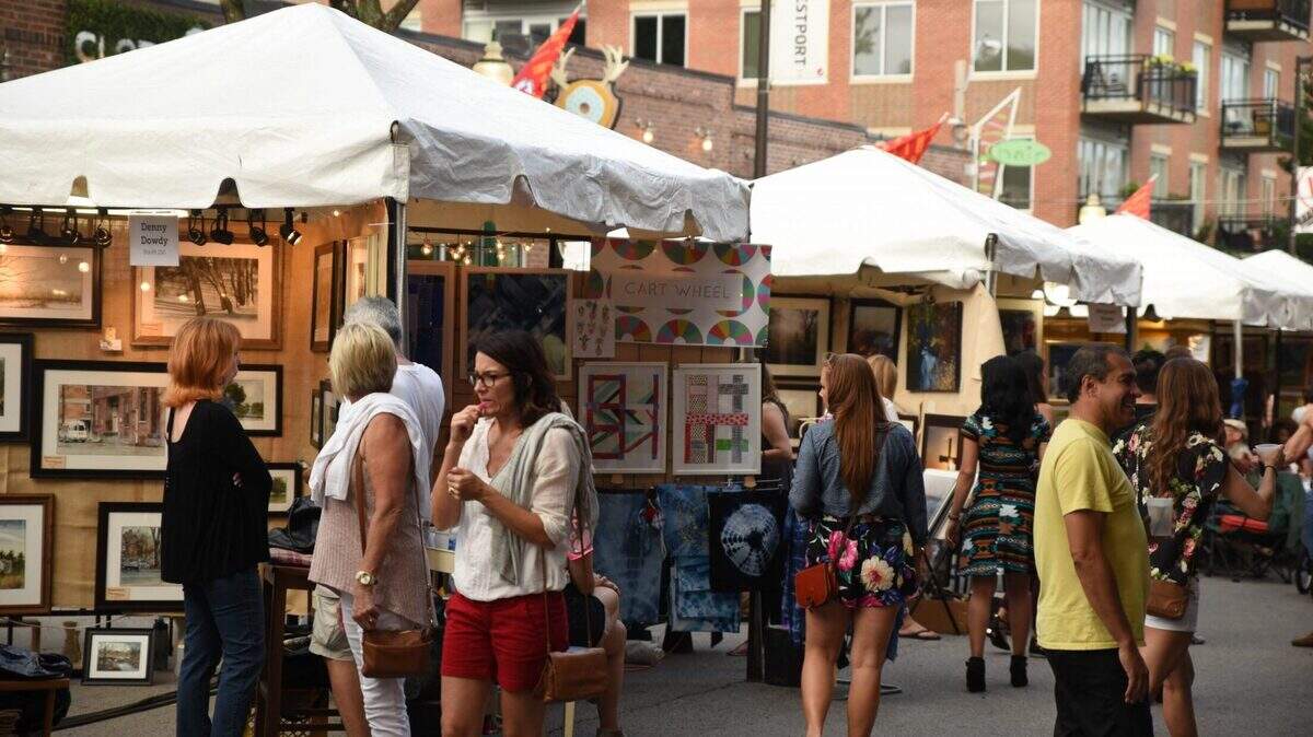 Kansas City residents looking and walking around the art displays during “Art Westport.” The art fair returns for its 42nd year this weekend.