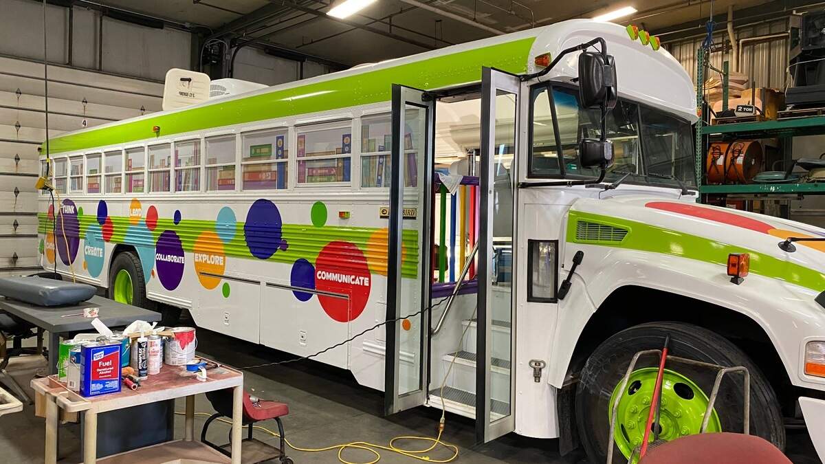 he bookmobile is an old school bus with a brand-new interior and paint job.