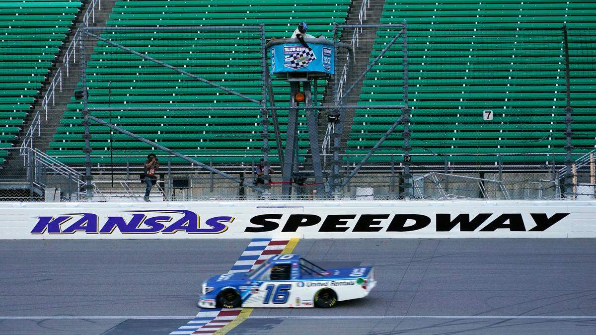 Austin Hill takes the checkered flag in Friday night’s NASCAR trucks race at Kansas Speedway in Kansas City, Kan.