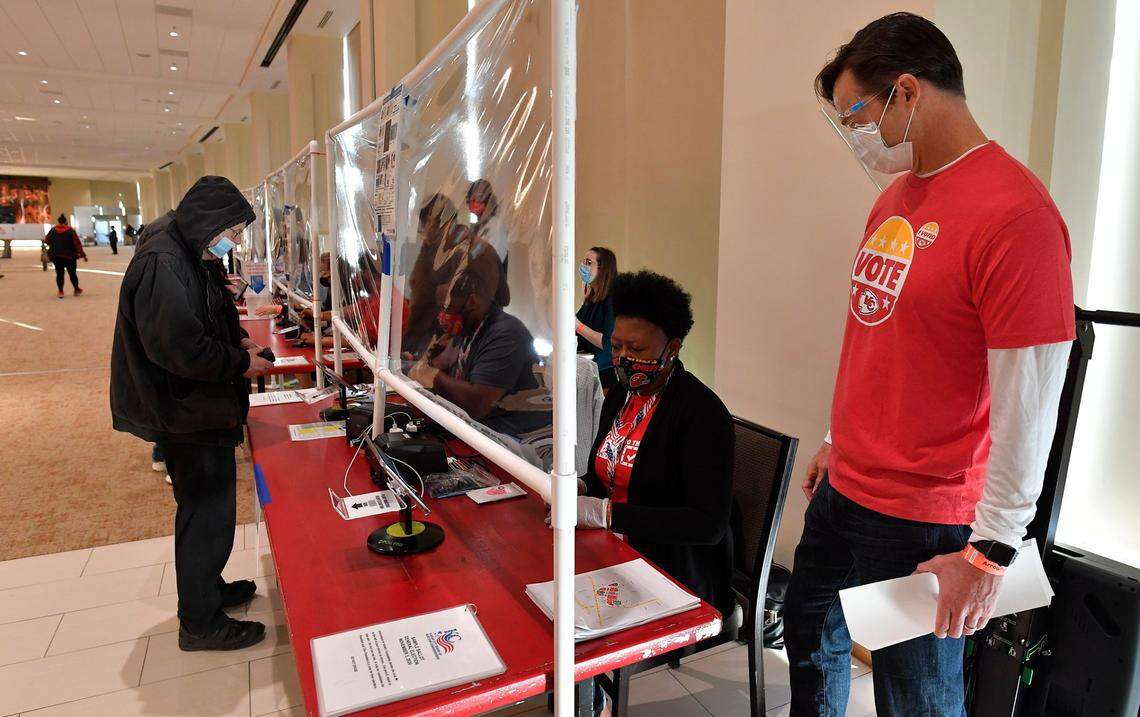 Kansas City Chiefs President Mark Donovan, right, visits with an election official Tuesday morning at Arrowhead Stadium, where for the first time people have been able to go and vote. ``It’s been rally amenable, the hospitality is great,’’ said DeLoach Draine, a coordinator with the Kansas City Board of Elections. ``We really appreciate their buy-in and support,’’ she said of the Chiefs organization.