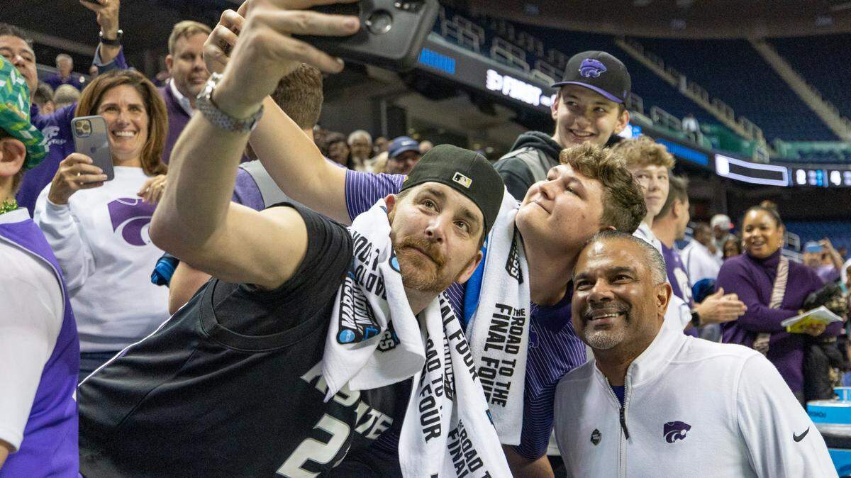 Kansas State coach Jerome Tang takes photos with Wildcat fans after picking up his first NCAA Tournament victory as a head coach against Montana State in Greensboro, N.C., on Friday, March 17, 2023.