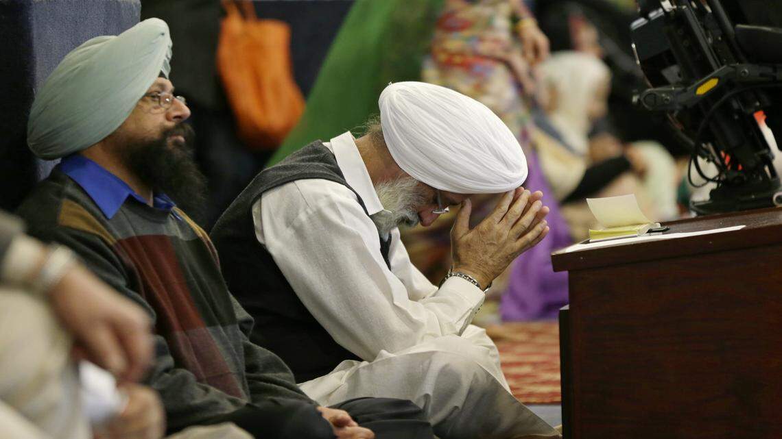 A man bows his head as he attends Sunday services at the Gurudwara Singh Sabha of Washington, a Sikh temple in Renton, Wash., Sunday, March 5, 2017, south of Seattle. Authorities said a Sikh man said a gunman shot him in his arm Friday, March 3, 2017, as he worked on his car in his driveway and told him "go back to your own country." Sikhs have previously been the target of assaults in the U.S. After the Sept. 11, 2001, attacks, as the backlash that hit Muslims around the country expanded to include those of the Sikh faith. 