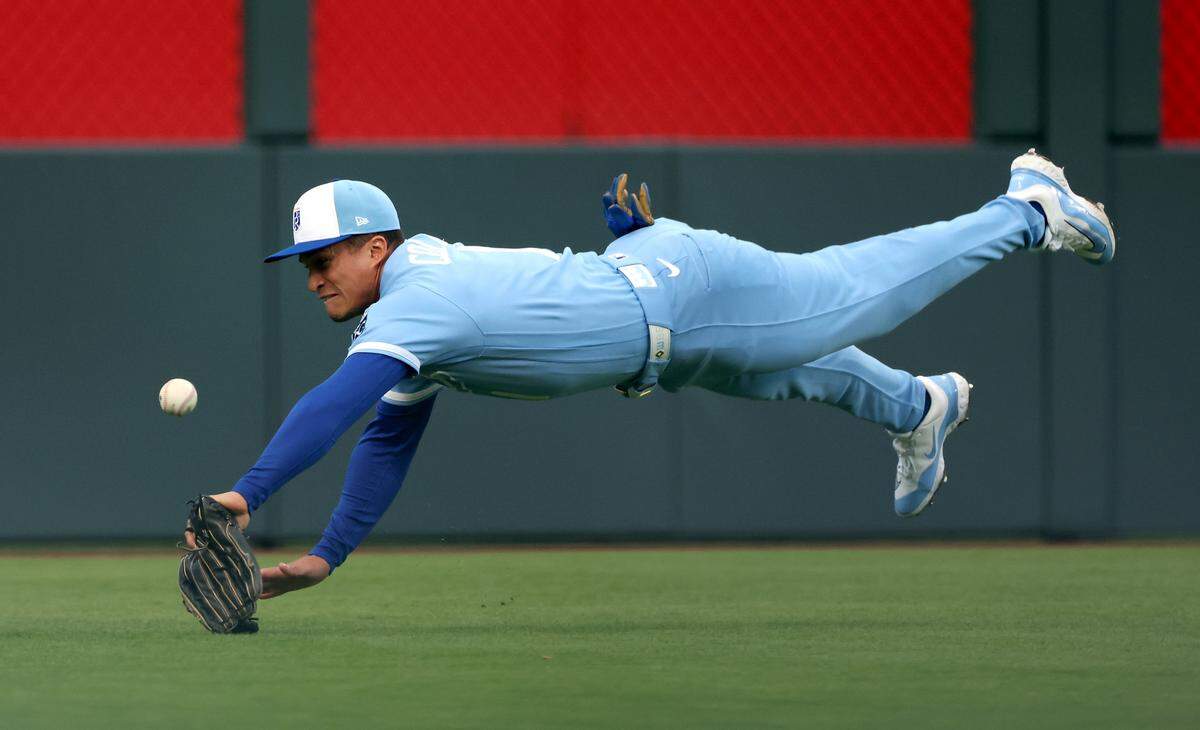 Royals left fielder Isaac Collins dives for a fly ball during a doubleheader nightcap against the Milwaukee Brewers at Kauffman Stadium in Kansas City on Saturday, April 4, 2026.