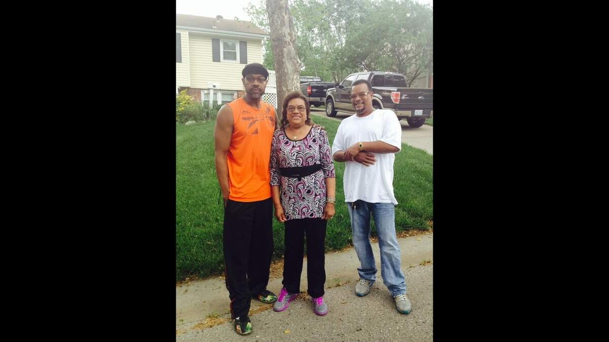 Nellie Bland (center) poses for a photo with her two sons, Wayne Cubit (left) and Darrell Cubit (right). She raised four children as a single mother while working for the Olathe School District.