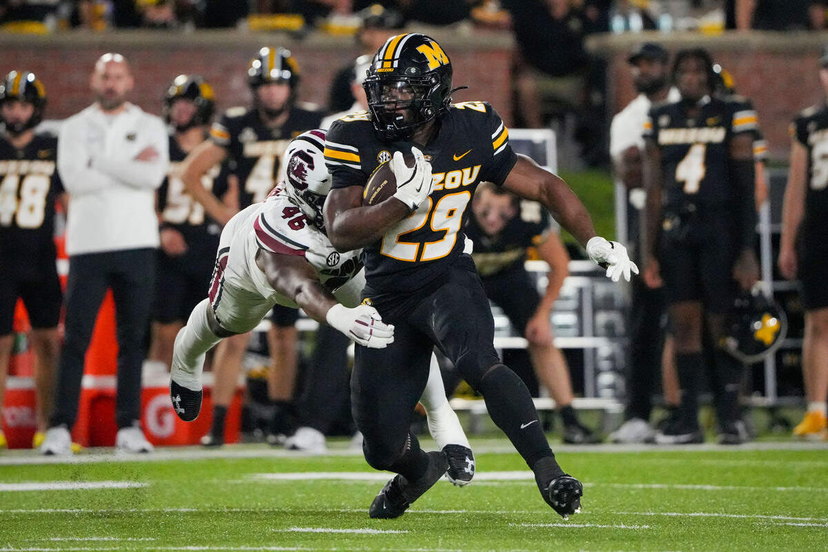 Missouri Tigers running back Ahmad Hardy (29) runs the ball as South Carolina Gamecocks linebacker Bryan Thomas Jr. (46) attempts to tackle him during the second half at Faurot Field at Memorial Stadium on Sept. 20, 2025.