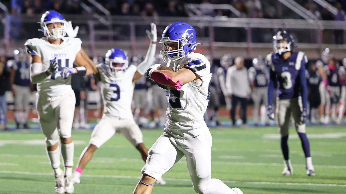 Colt Nolin scores a touchdown to wrap up Liberty’s 36-13 win against Oak Park in a Friday night high school football showdown at Oak Park.