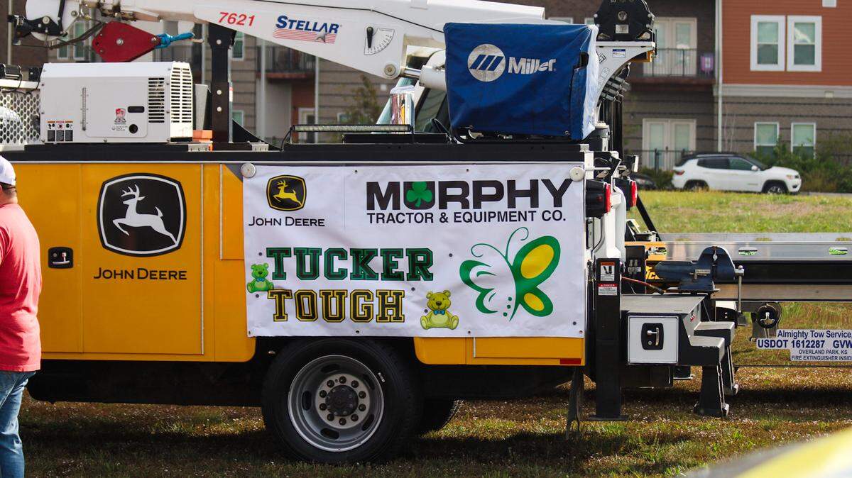 A sign reading “Tucker Tough” is seen on a truck participating in a parade honoring Tucker Langford, 3, who is battling terminal illness on Saturday, Oct. 11, 2025.
