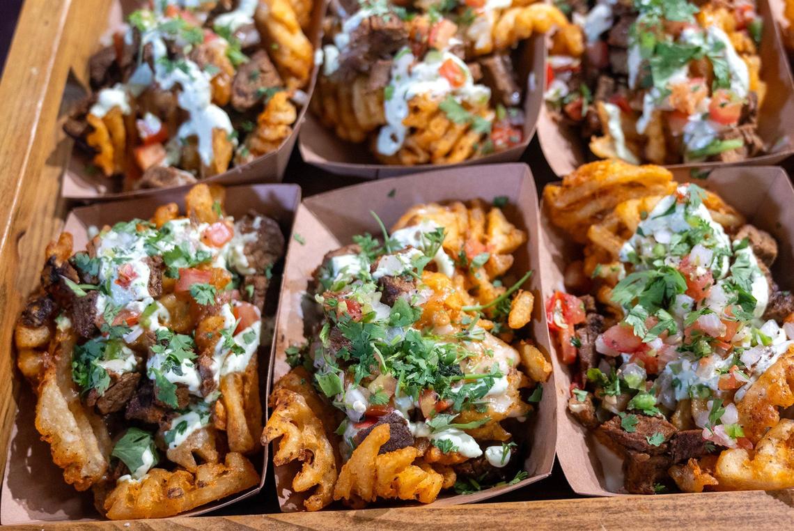 Carne Asada Waffle Fries is a new offering from Levy for Club Concessions at GEHA Arrowhead Stadium. The item features waffle fries with ancho rubbed tri tip, queso blanco, pico de gallo and lime crema.
