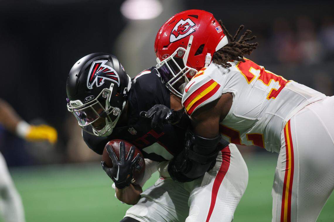 Atlanta Falcons wide receiver Darnell Mooney is tackled by Kansas City Chiefs linebacker Nick Bolton during Sunday night’s game at the Mercedes-Benz Stadium.