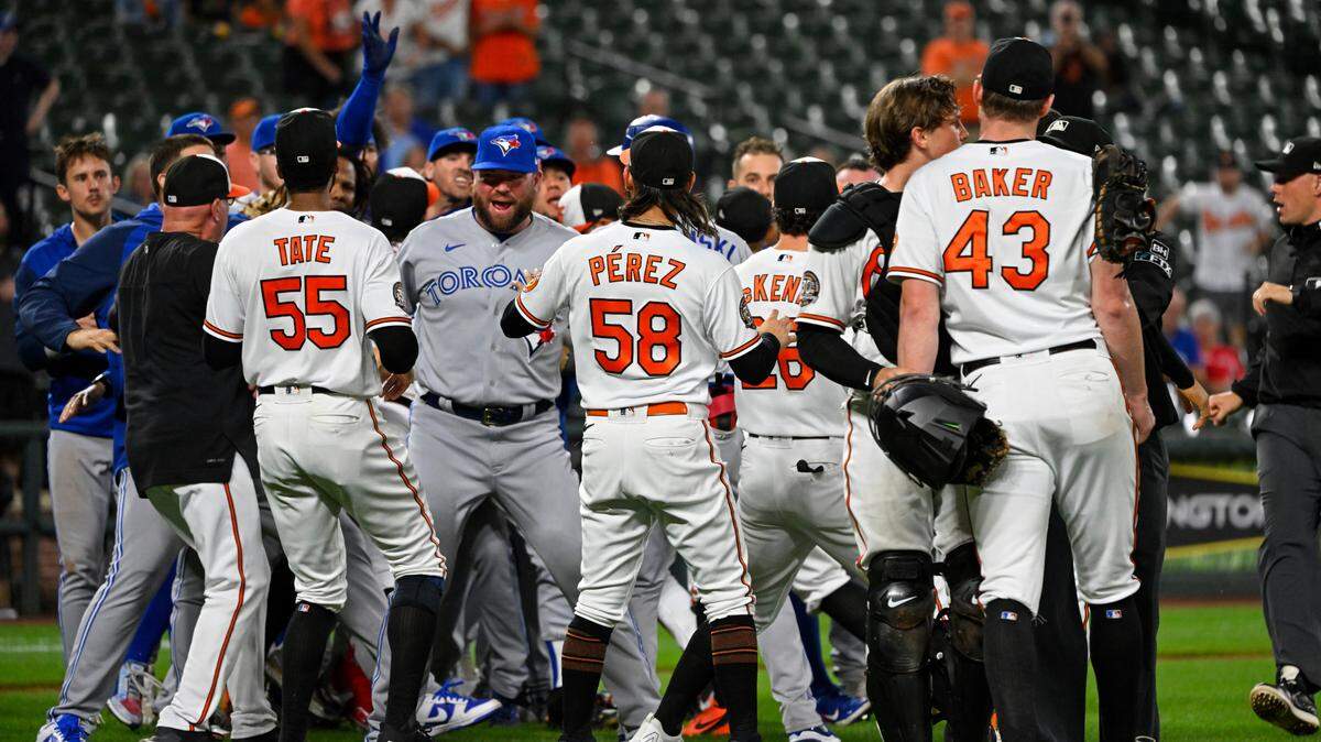 Baltimore Orioles relief pitcher Bryan Baker (43) is restrained by Baltimore Orioles catcher Adley Rutschman as both teams benches clear during the seventh inning a baseball game, Tuesday, Sept. 6, 2022, in Baltimore. (AP Photo/Terrance Williams)