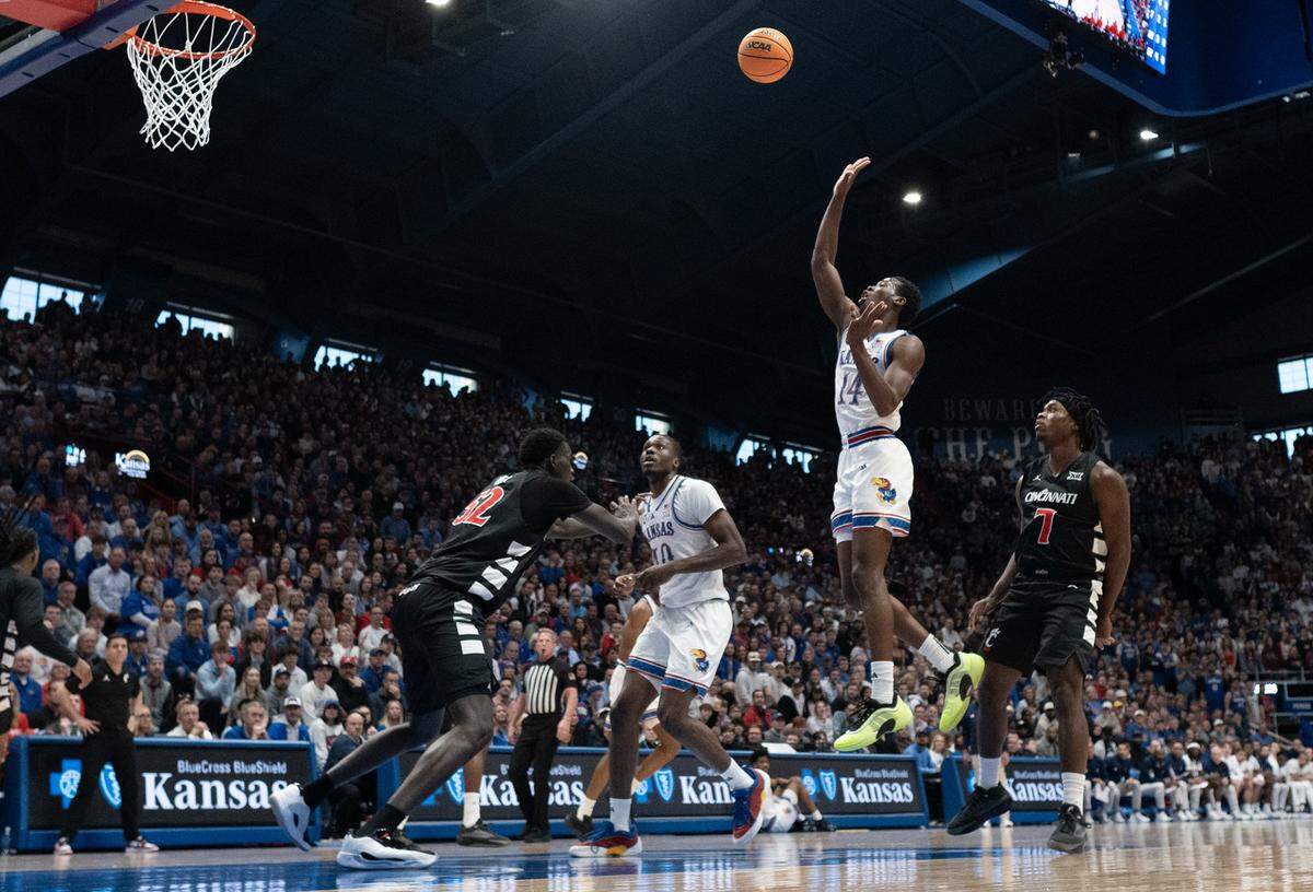 Kansas Jayhawks guard Melvin Council Jr. (14) gets high as he shoots against the Cincinnati Bearcats in the first half at Allen Fieldhouse on Saturday, Feb. 21, 2026, in Lawrence, Kansas.