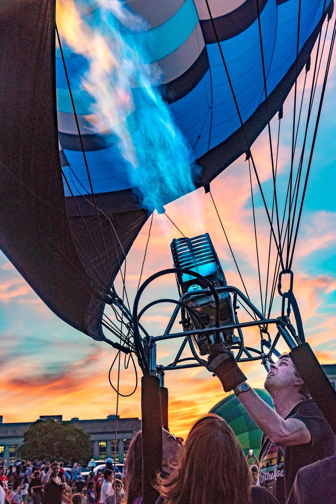A balloon pilot fires up his burner to make his balloon glow at the Great Balloon Glow Saturday, August 20, 2022, at the National World War I Museum and Memorial.