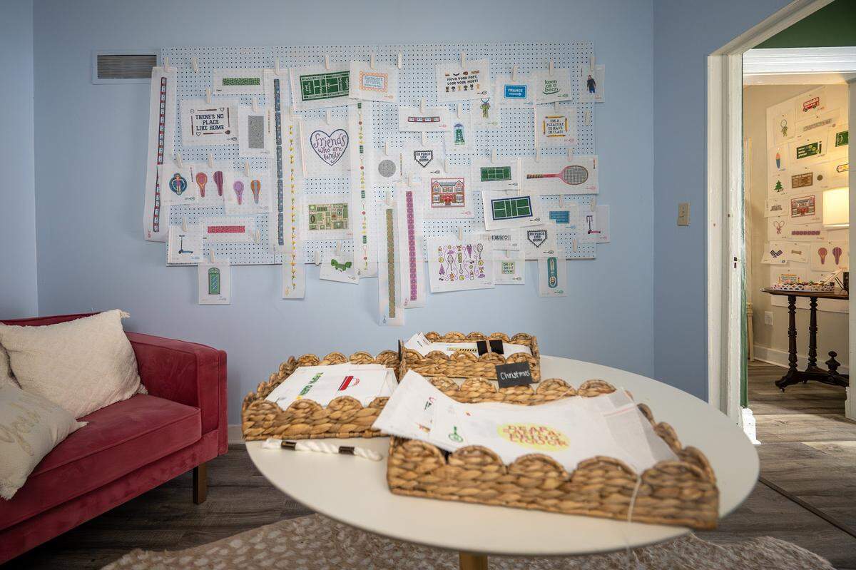 Needlepoint canvases are displayed for sale on a board at The Parkville Needlepoint House on Wednesday, Feb. 11, 2026, in Parkville.