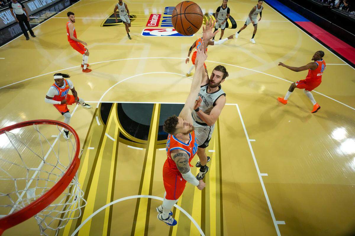 Luke Kornet #7 of the San Antonio Spurs shoots over Isaiah Hartenstein #55 of the Oklahoma City Thunder during the first quarter at T-Mobile Arena on December 13, 2025 in Las Vegas.