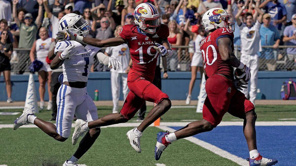 Kansas running back Daniel Hishaw Jr. (No. 20) scores a touchdown during Saturday’s game against Duke at Booth Memorial Stadium in Lawrence, Kan.