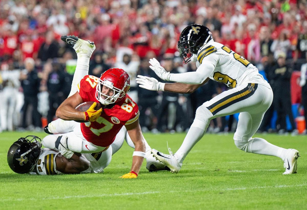 Chiefs tight end Travis Kelce (87) gets tackled in the first half against the New Orleans Saints at GEHA Field at Arrowhead Stadium on Monday, October 7, 2024.