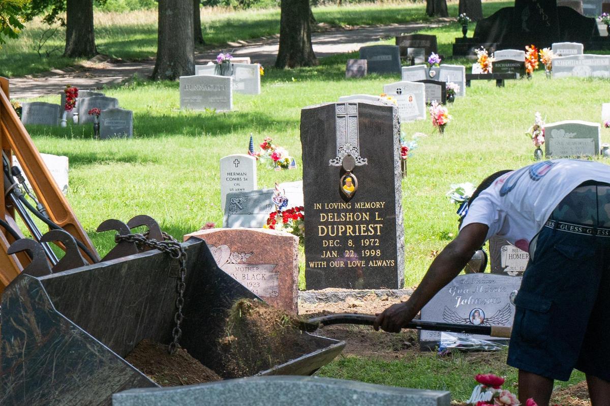 Forest Hill Cemetery worker Larry Cunningham works near the gravesite of deceased Delshon L. Dupriest on Wednesday, July 2, 2025 in Kansas City, after the body was illegally disturbed.