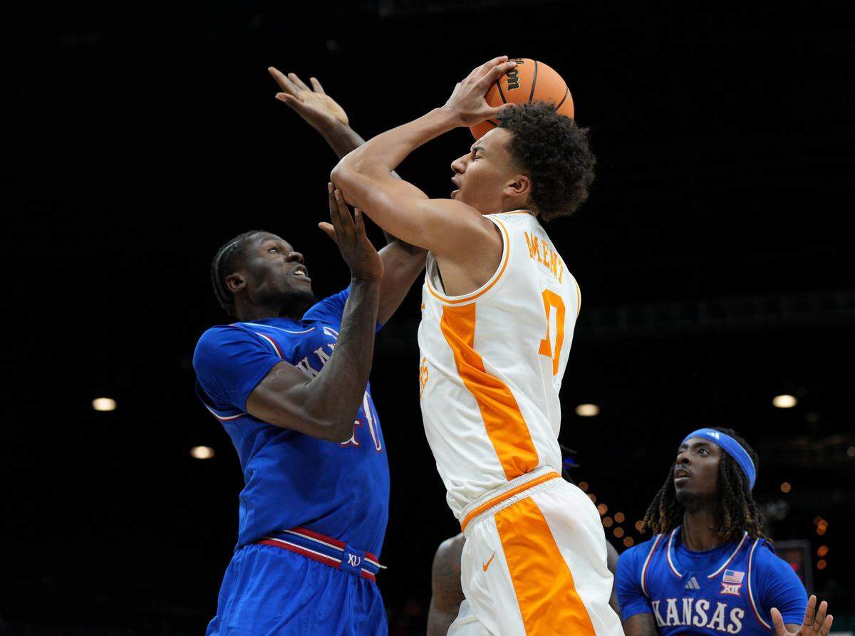 Kansas Jayhawks center Flory Bidunga, left, gets a hand in the face of Tennessee Volunteers counterpart Nate Ament during a Players Era men’s basketball tournament game at the MGM Grand Garden Arena in Las Vegas on Wednesday, Nov. 26, 2025.