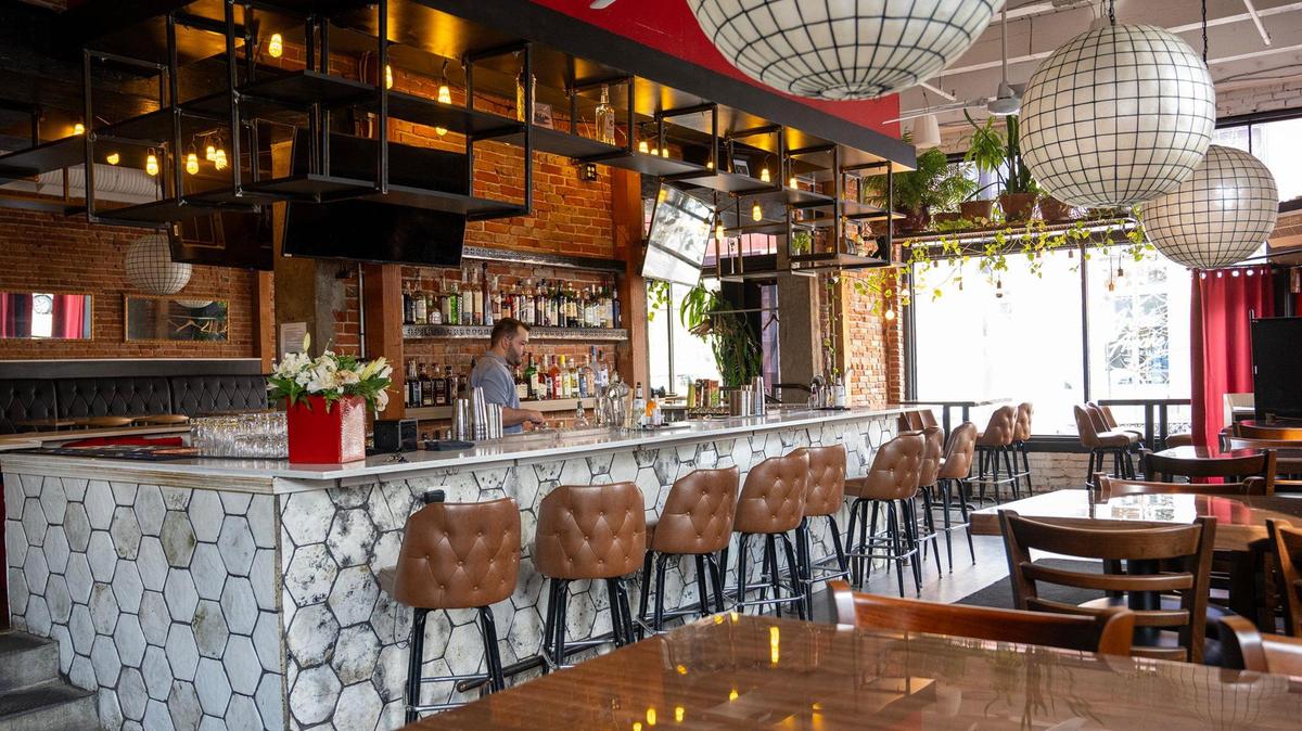 Bartender Ryan Elder preps the bar at Muni, which has moved into the former Tribe space in the River Market.